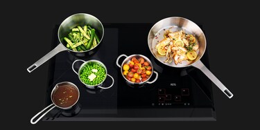 Pots and pans filled with food on a MaxiSense hob