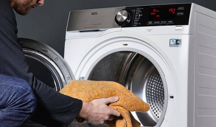 man filling washing machine